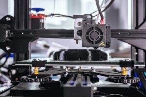 The 3D printer prints black plastic model